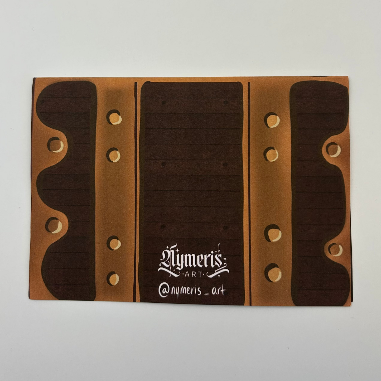 Wooden business card holder with brand name on a light gray background