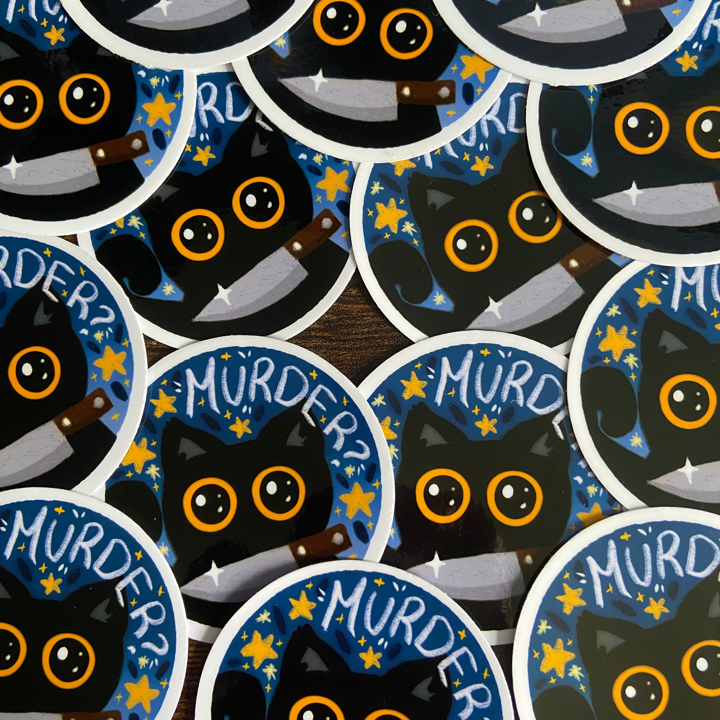 Stickers with black cat illustrations and 'MURDER?' text on a blue background.