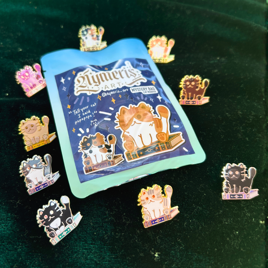 Collection of cat-themed pins on a green velvet background with a 'Nymeris Art' card.