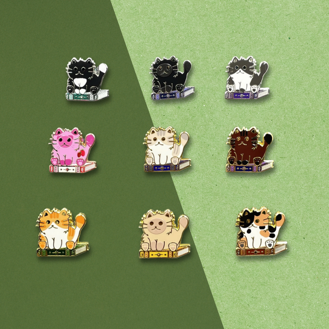 Set of cat-themed pins on a green and gray background