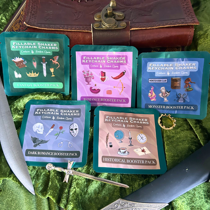 Collection of 'Fillable Shaker' booster packs on a green fabric background with decorative elements.