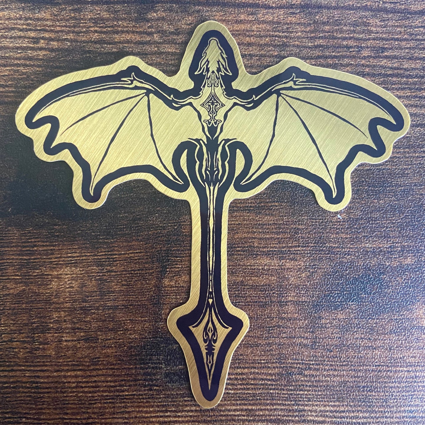 Decorative dragon emblem on a wooden surface