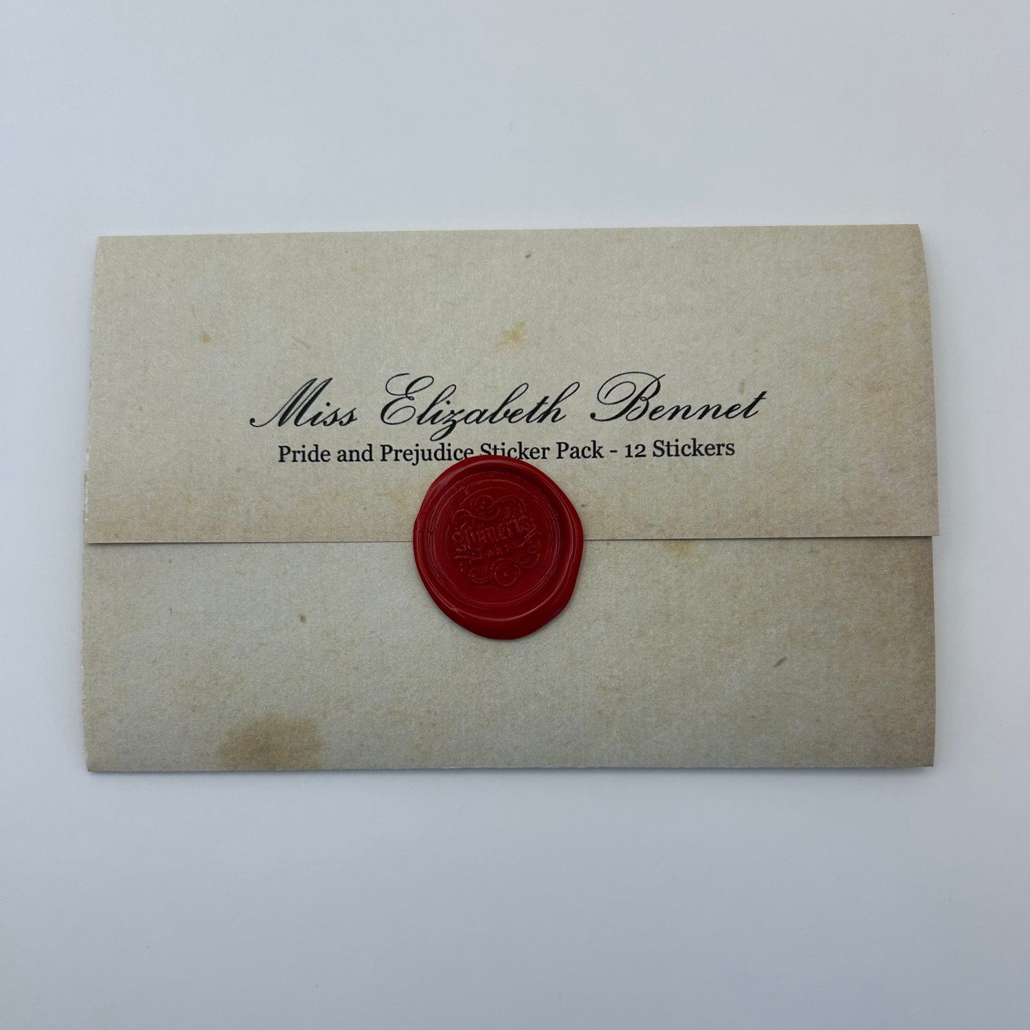 Envelope with 'Miss Elizabeth Bennet' text and red wax seal on a white background