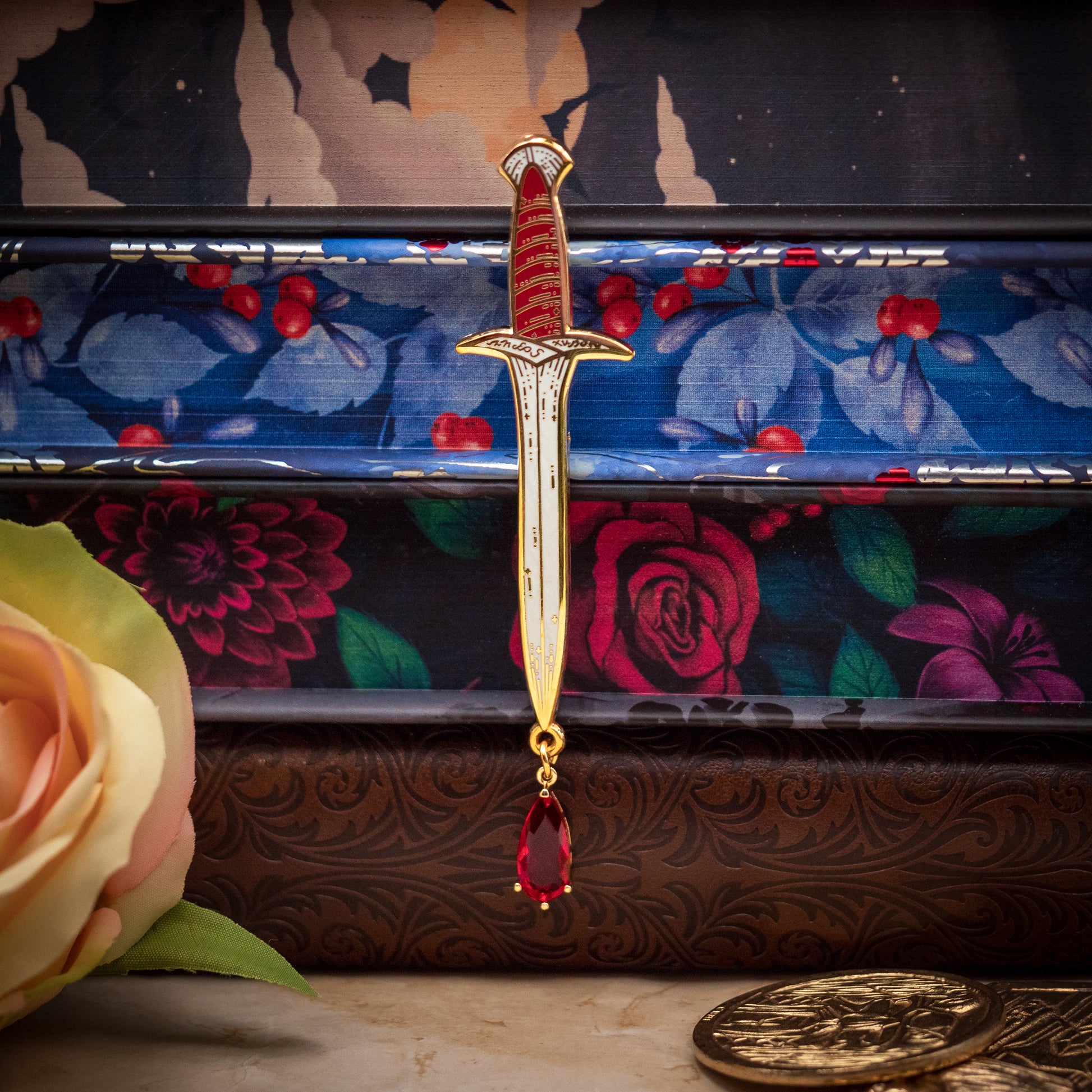 Dagger enamel pin with a blood drop