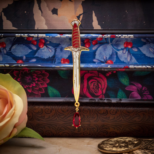 Dagger enamel pin with a blood drop