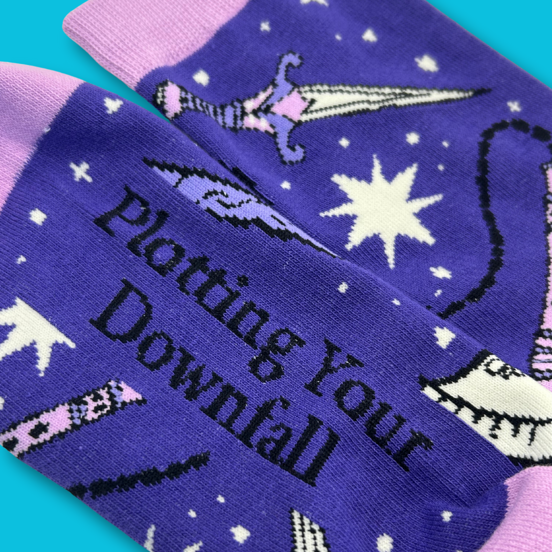 Purple socks with text and star design on a teal background