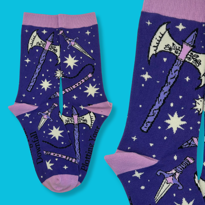 Purple socks with fantasy-themed designs on a blue background
