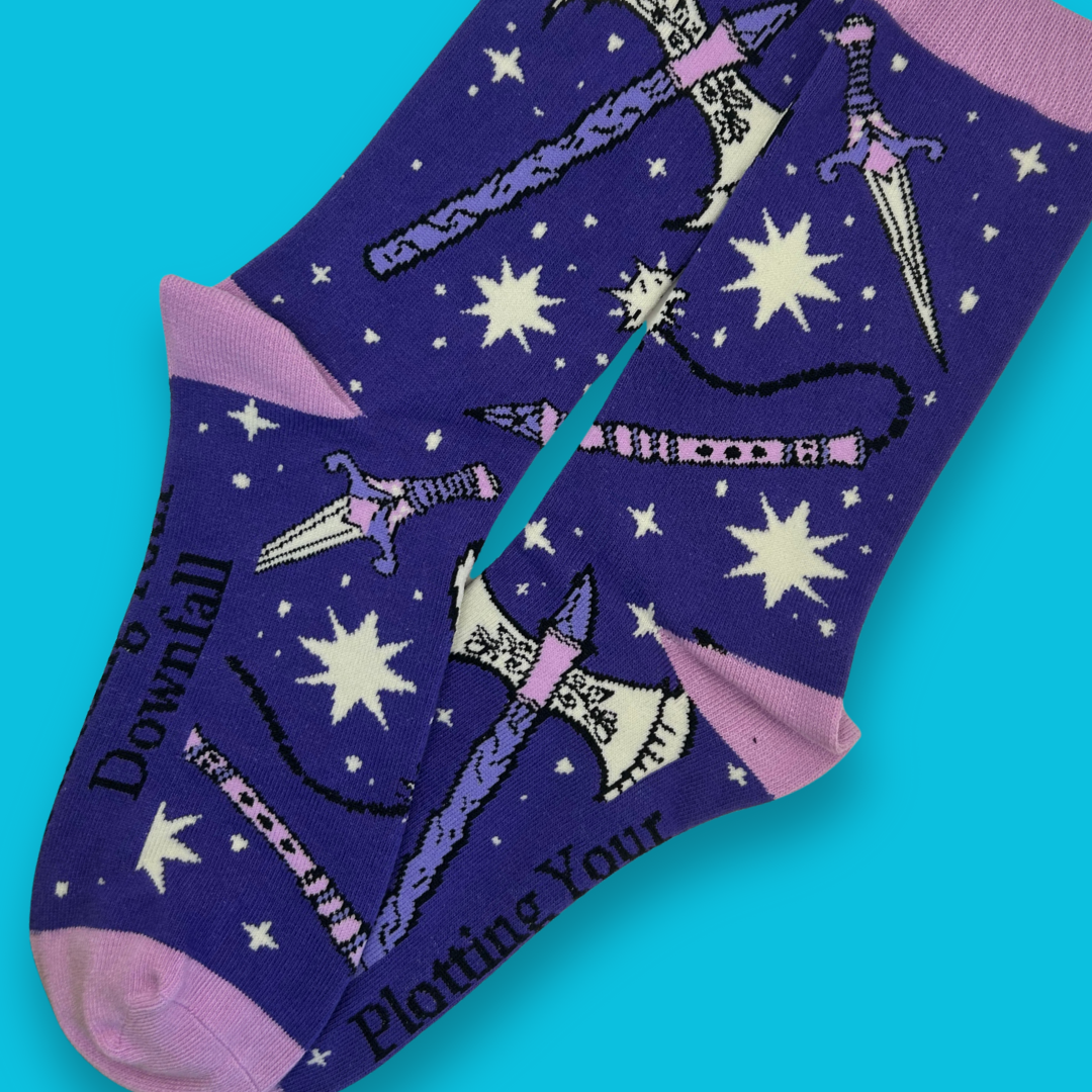 Purple socks with star patterns and text on a blue background