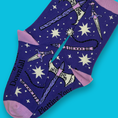 Purple socks with star patterns and text on a blue background