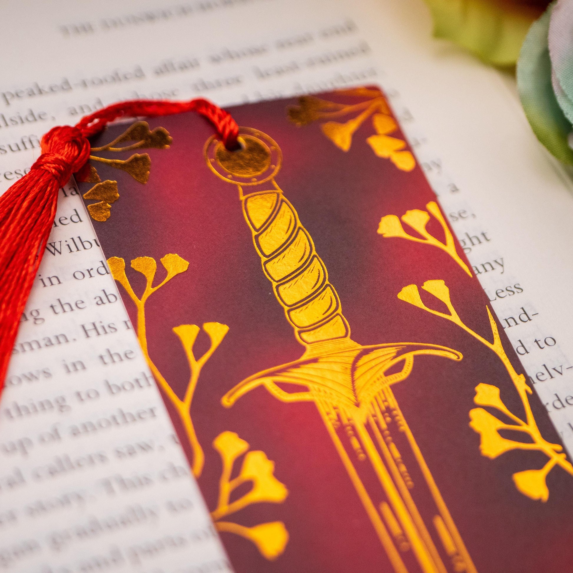 Elegant baby’s breath and dagger design with gold foil detailing, perfect for fantasy and dark academia lovers