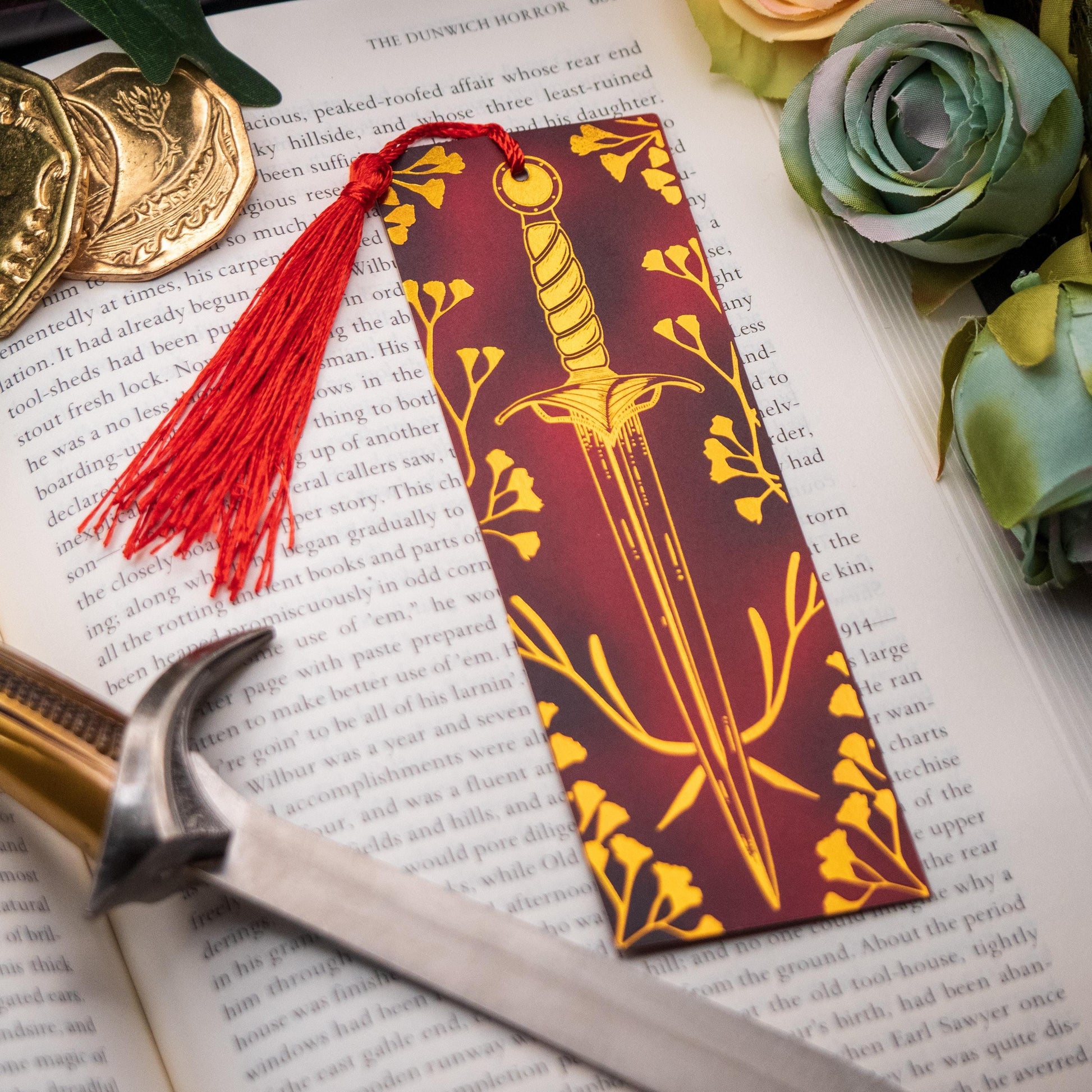 Gold foil dagger bookmark featuring delicate baby's breath on smooth cardstock, available with or without a red tassel